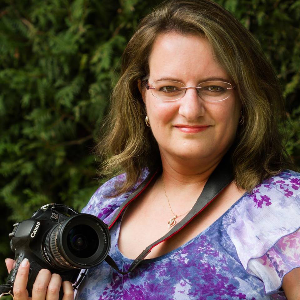 A photo of Purple Door Creative owner Paula Kennedy holding a canon camera