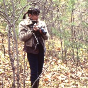 A photo of a young Paula Kennedy with a camera